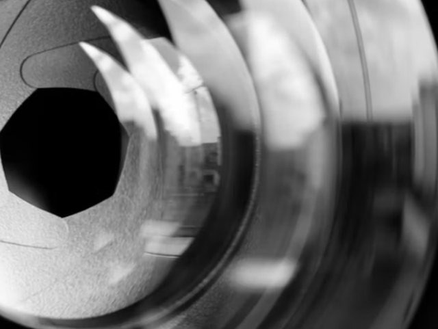 Macro view of a camera lens iris with its aperture blades stopped down